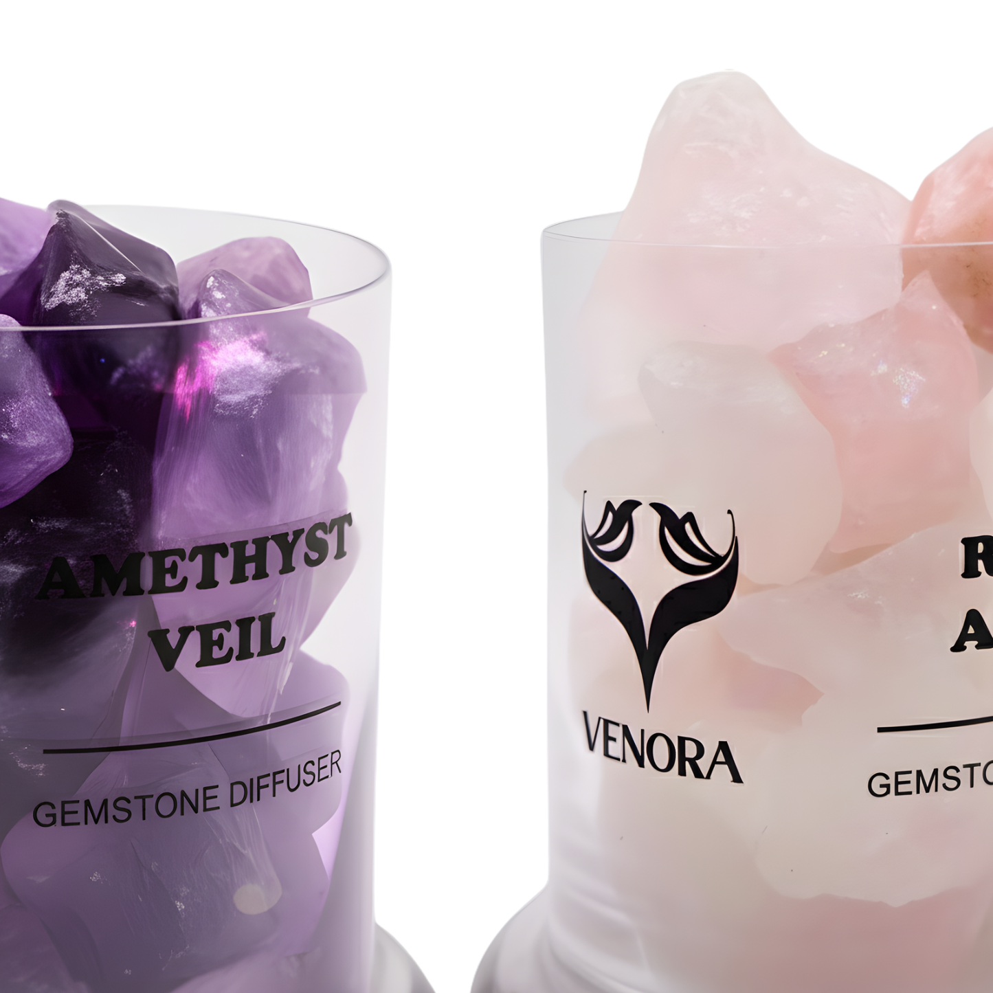 Close-up of amethyst and rose aura quartz crystals showing soft lavender and pink reflections in elegant lighting.