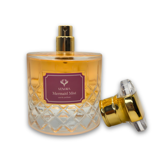 Mermaid Mist perfume displayed with cap on and cap off showing the spray nozzle in a luxury product shot.