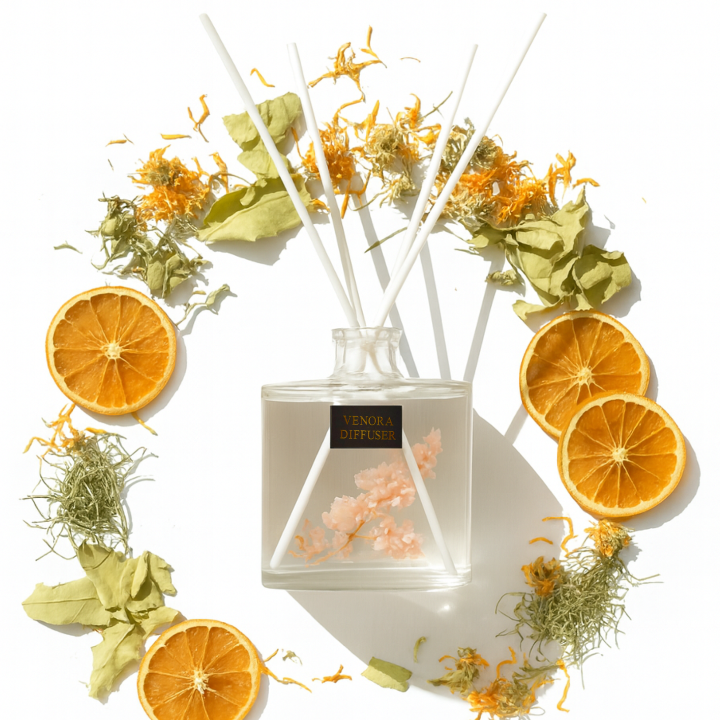 Minimalist flatlay of Venora Secret Garden diffuser surrounded by bergamot, white tea, cypress, calendula, and dried botanicals in a luxury layout.
