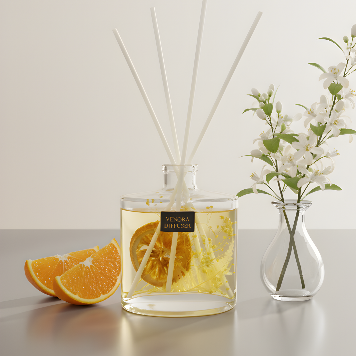 Venora Reed Diffuser Collection featuring Citrus Glow, Golden Peach, and Secret Garden luxury flameless home fragrances in clear glass bottles with natural dried botanicals.