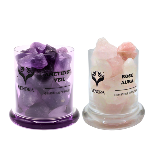 Amethyst and Rose Aura gemstone diffusers surrounded by polished amethyst and rose aura crystals arranged elegantly on a clean background.