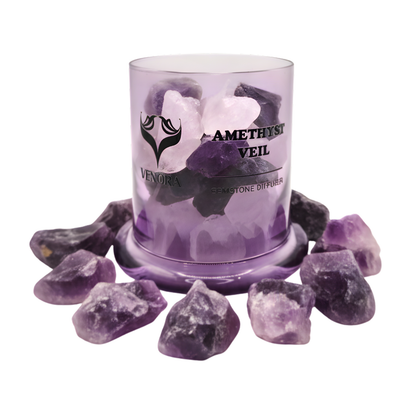 Amethyst Veil diffuser surrounded by polished amethyst stones arranged elegantly at the base on a clean white background.