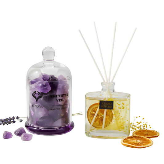 Amethyst Veil and Citrus Glow diffusers styled with amethyst crystals, citrus slices, and dried botanicals in an elegant arrangement.