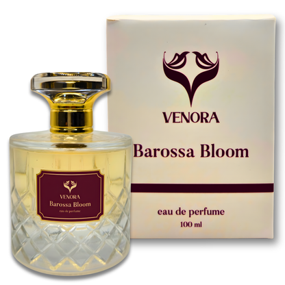 Close-up of Barossa Bloom perfume bottle showing glass texture, label details, and soft golden reflections.