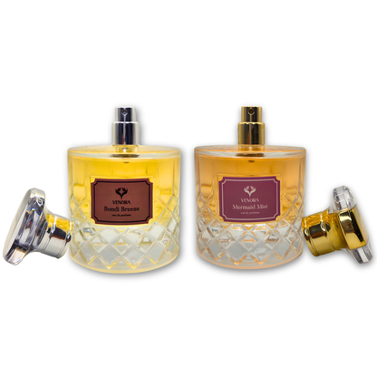 Bondi Breeze and Mermaid Mist perfumes styled together to show masculine and feminine contrast in a luxury fragrance pairing.