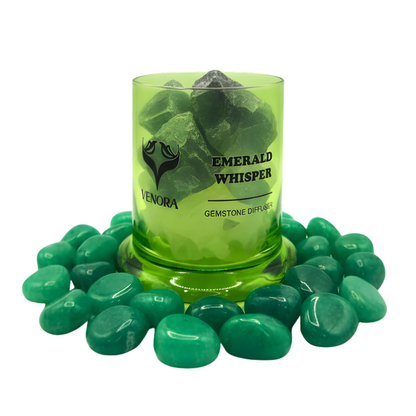 Emerald Whisper diffuser surrounded by polished emerald stones arranged elegantly at the base on a clean white background.