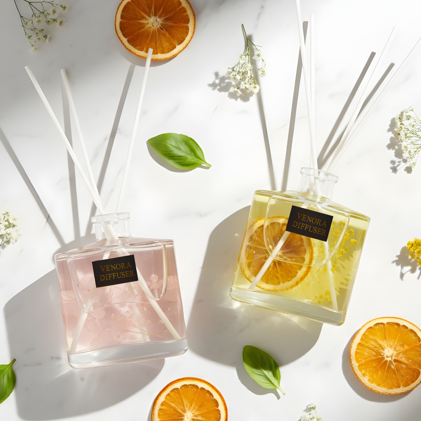 Flatlay of the Home Glow Gift Set with both diffusers, reeds, citrus elements, and floral botanicals arranged in a premium minimal style.