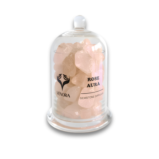 Rose Aura Gemstone Diffuser by Venora with genuine rose aura quartz crystals inside a clear glass vessel on a white background.
