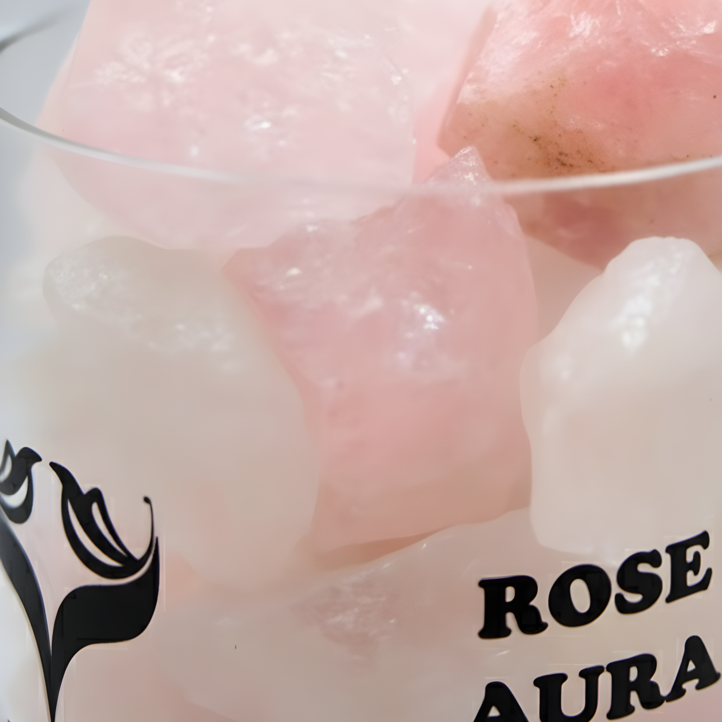 Close-up of rose aura quartz crystals inside the Rose Aura diffuser with soft pink reflections and elegant lighting.