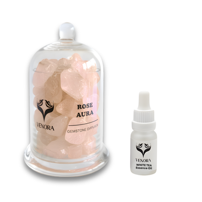 Rose Aura crystal diffuser displayed with its white tea essence oil bottle beside it in a luxury aromatherapy ritual setup.